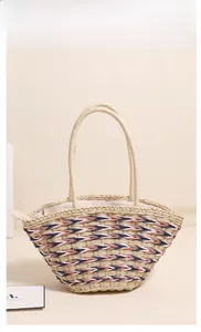 Detail shot of khaki woven straw tote bag with colorful pink and navy striped patterns