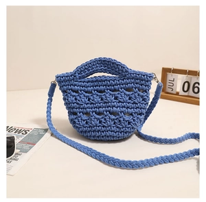 Detailed close-up of blue crochet knit bag showing texture with a vintage aesthetic background
