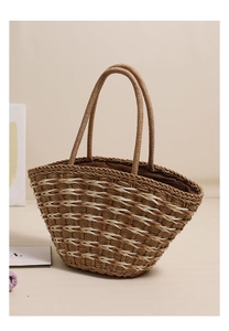 Detail of hand-woven straw tote with tri-color wave pattern and durable brown fabric lining