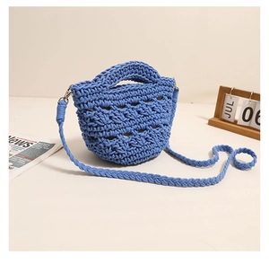 Detailed close-up of blue crochet knit bag showing intricate hollow cotton rope texture