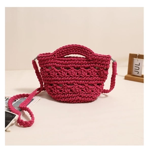Close-up of pink hand-woven cotton phone bag with crochet texture and metal buckle