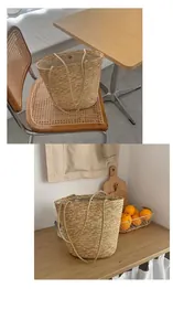 Detail of minimalist straw tote bag featuring woven texture and silver magnetic snap closure