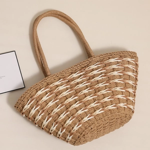 Handwoven straw tote bag with brown and white wave pattern for summer beach vacations