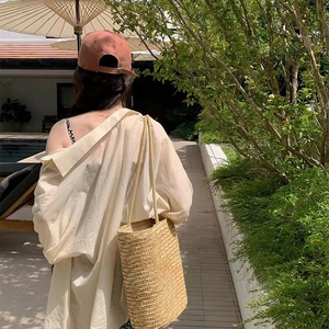 Minimalist large straw shoulder bag with woven texture for summer beach vacations