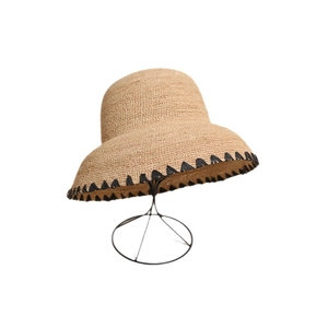Handwoven raffia sun hat with black scalloped trim and vintage round crown for beach style
