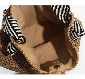 Top view of woven tote bag showing internal lining and magnetic metal buckle closure