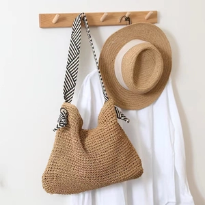 Straw shoulder bag with striped woven straps for beach vacation and summer styling