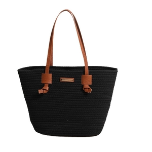 Handwoven black cotton tote bag with brown leather straps and gold metal plate