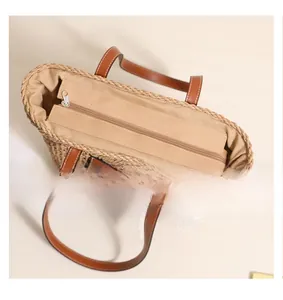 Detail view of smooth zipper closure and spacious interior of the straw tote bag
