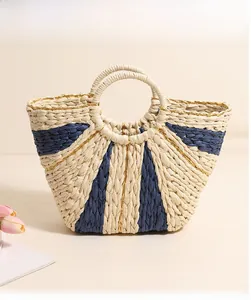 Detail of handwoven tote bag featuring contrast stripes and golden thread texture