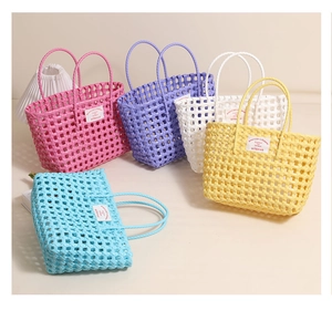 Close-up of colorful woven plastic beach bags with brand label and hollow grid texture