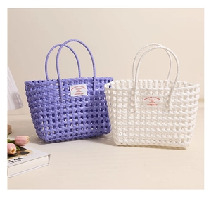 Close-up of woven plastic tote bags with cutout mesh design and brand label detail