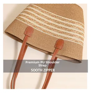 Detail of premium PU leather shoulder strap and woven straw texture on large beach tote bag