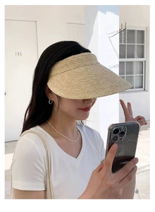 Detail of hand-woven raffia wide brim sun hat with a minimalist open top design