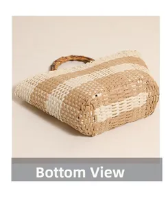 Detailed bottom view of striped straw handbag showing the woven texture and structure