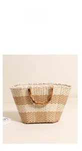 Detail of hand-woven straw tote with bamboo handles and chic khaki striped pattern