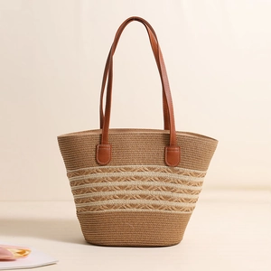 Striped straw tote bag with brown faux leather handles for summer beach vacations