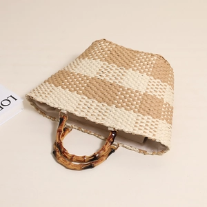Straw woven tote bag with bamboo handles and striped pattern for beach vacation