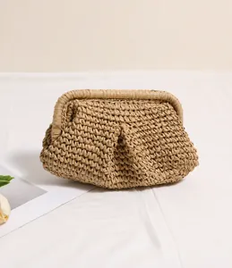 Close-up of pleated straw clutch bag with natural woven texture in beige summer style