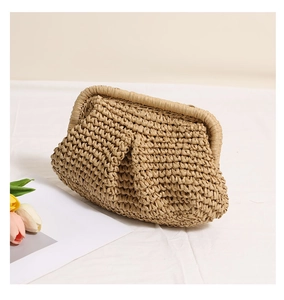 Detail of handwoven straw clutch featuring a pleated cloud design in natural khaki