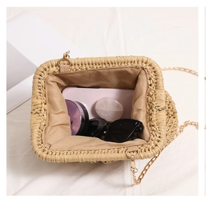 Top view of woven straw bag interior showing large capacity for phone and sunglasses
