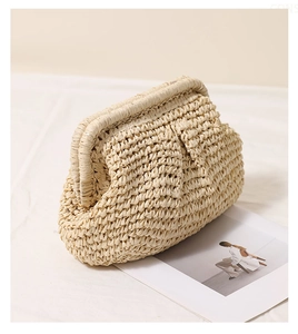 Detailed macro view of the natural beige woven texture on this summer pleated straw bag