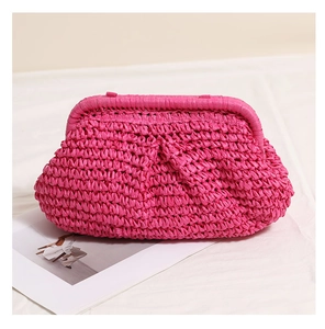 Detail of hand-woven magenta straw clutch bag with unique pleated wave texture