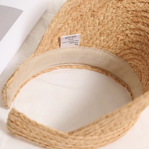 Handwoven raffia sun hat with internal sweatband details and premium straw texture