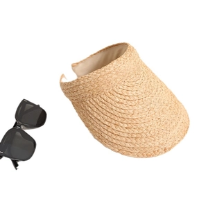 Handwoven raffia sun visor hat for beach vacations with sunglasses on white background