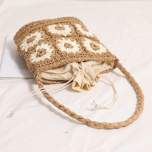 Handmade straw shoulder bag with white daisy flowers and secure drawstring lining