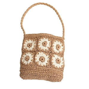 Handmade woven straw shoulder bag featuring daisy flower crochet patterns for beach holidays