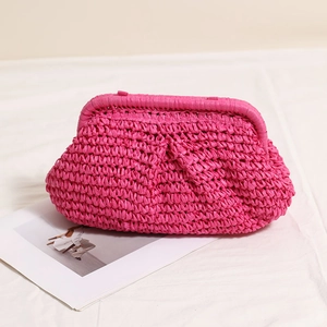 Handmade magenta woven straw clutch bag with a pleated cloud design for beach holidays