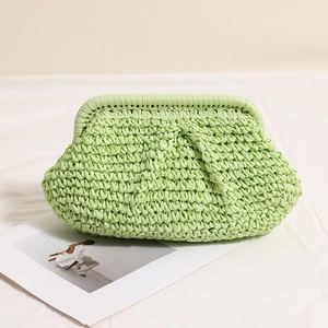 Light green pleated straw clutch bag with woven texture for beach and vacation style