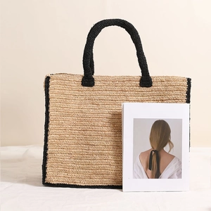 Square raffia woven tote bag with black trim and large capacity for beach vacation