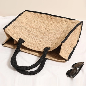 Large square raffia straw tote bag with black contrast trim for summer beach vacation