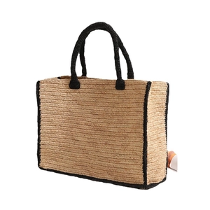 Minimalist raffia straw tote bag with black trim and large capacity for beach vacation