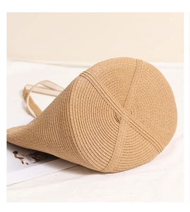 Detail of reinforced circular bottom and cross stitching on a straw beach bag