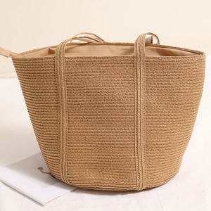 Minimalist straw tote bag in khaki with large capacity and woven texture for beach holidays