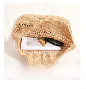Detailed view of spacious interior of hand-woven straw tote bag with mesh design