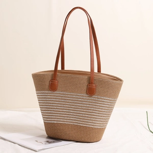 Woven straw tote bag with silver horizontal stripes and brown leather shoulder straps