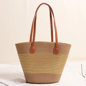 Large straw tote bag with yellow horizontal stripes and brown leather handles for beach vacation