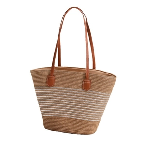 Khaki woven straw tote bag with white horizontal stripes and brown leather handles