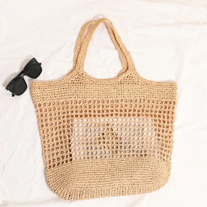 French style large woven straw tote bag with cutout net design for beach vacations