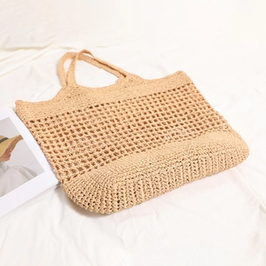 French style large woven straw tote bag with cutout shoulder straps for beach vacation