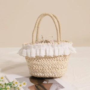 Handmade corn husk woven straw bag with delicate lace trim for summer beach vacations