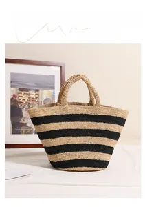 Close-up of the raffia woven pattern with black horizontal stripes on a beach tote bag