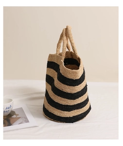 Close-up of striped raffia woven tote bag texture with large capacity design