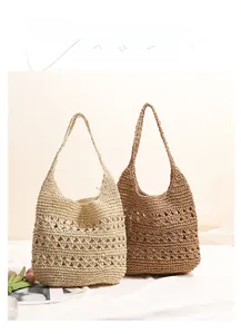 Detail of hollow-out crochet pattern on summer straw tote bags in beige and brown