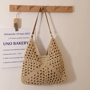 Hollow out woven straw tote bag in beige with brown leather straps for beach holidays