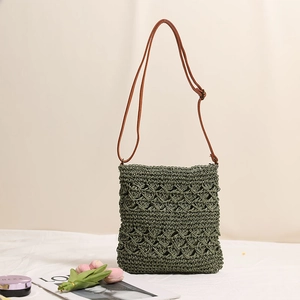 Dark green woven crossbody straw bag with brown leather strap for summer beach vacation